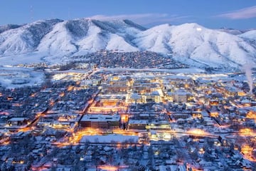 Town of Golden at night with glowing lights and snow capped mountains